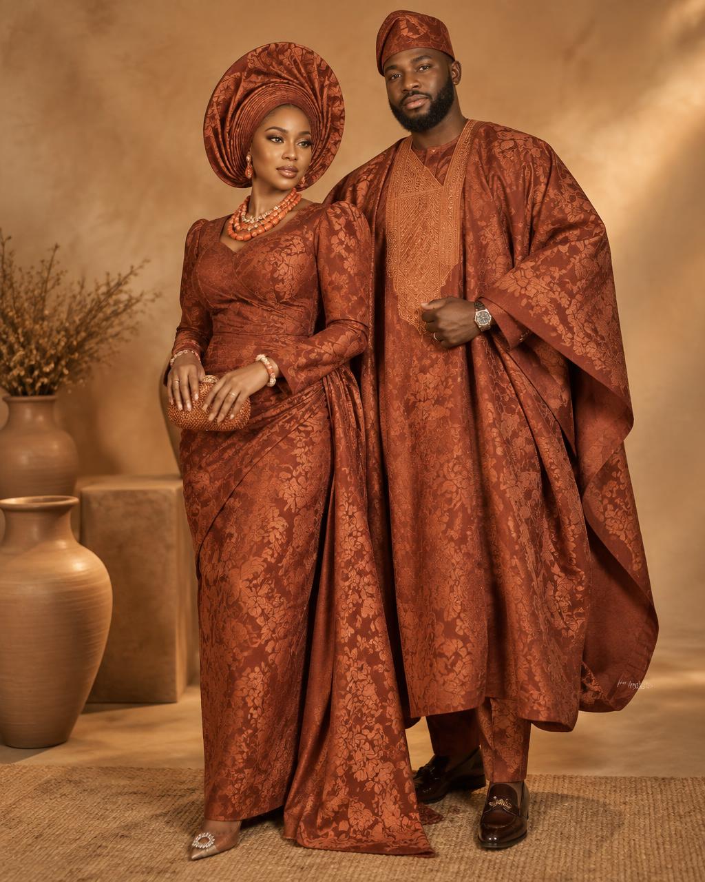 A couple dressed in terracotta brocade Aso-oke attire